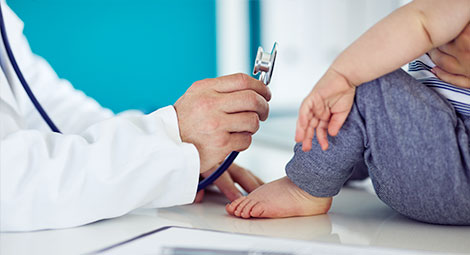 Doctor using a stethoscope on a patient